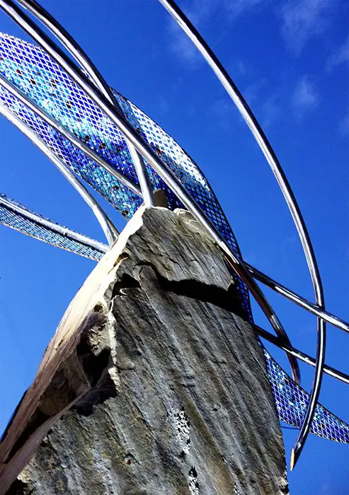 A close up of the side of a tree with wires hanging from it.