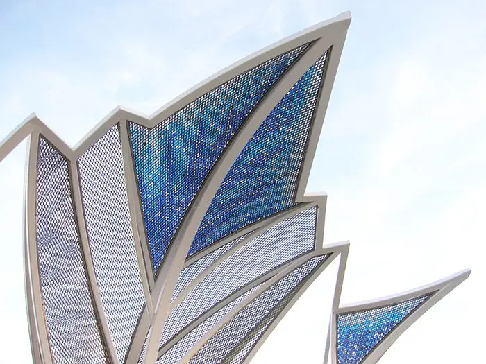 A close up of the top of a building with blue and white stained glass.