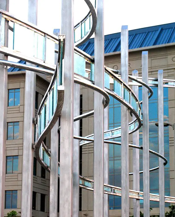 A metal spiral staircase in front of a building.