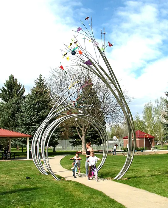 A group of people standing around in the grass.