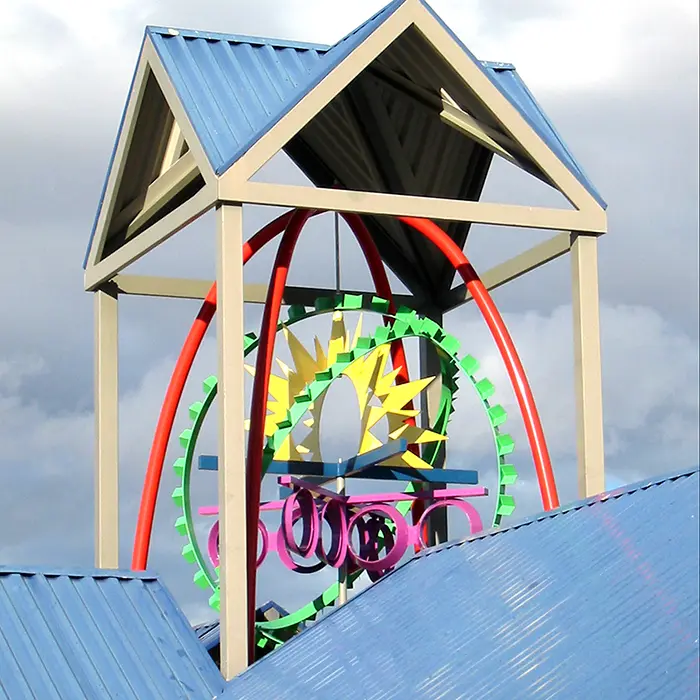 A wooden structure with a colorful ferris wheel on top of it.