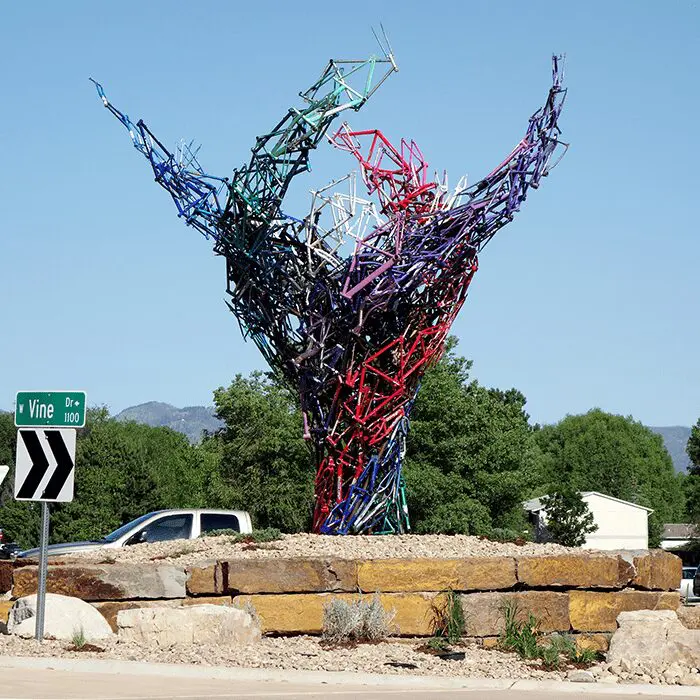 A sculpture of a tree with colorful branches.